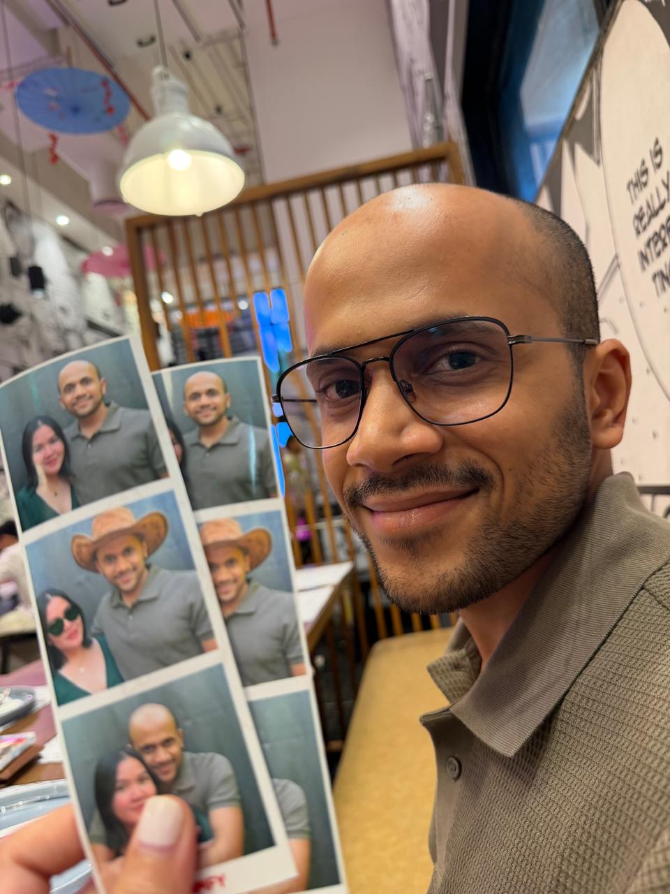 Aabhas holding our photobooth strips