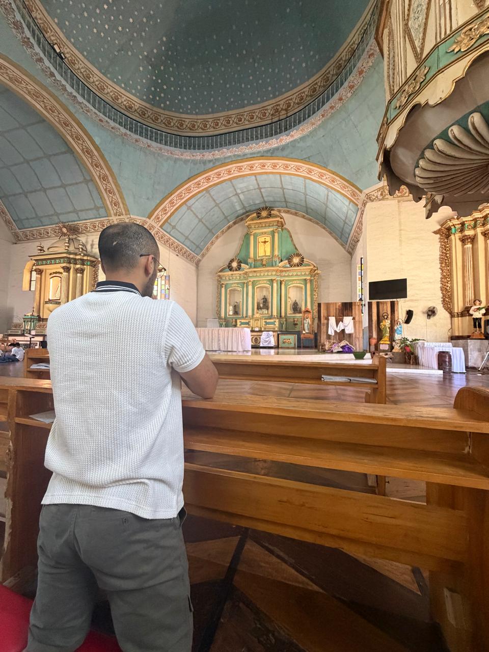 Aabhas praying in a church in Siquijor
